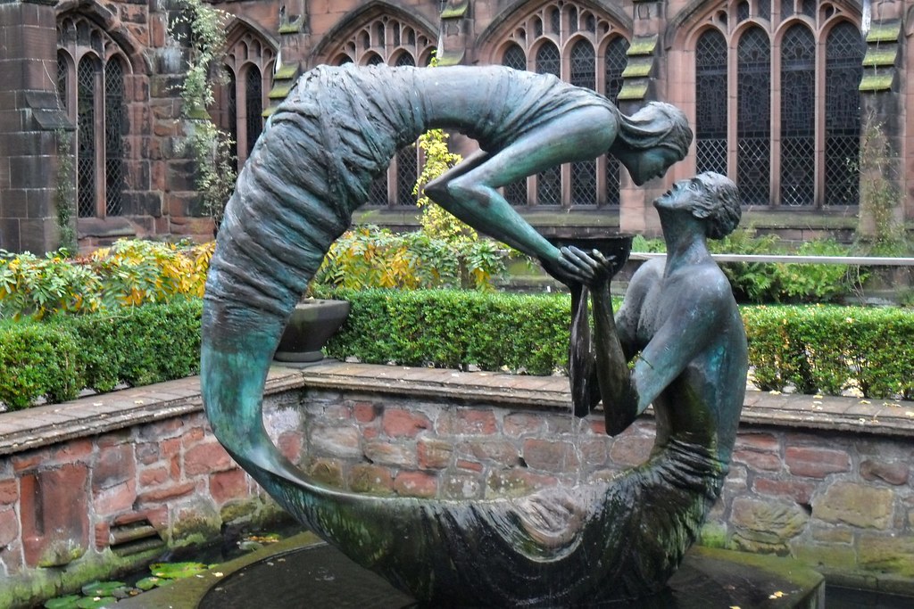 "The Water of life" statue by Stephen Broadbent at cloister garden of Chester Cathedral. UK
