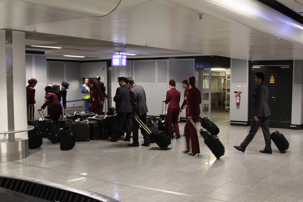 Qatar Airways cabin crew collect their baggage at the othe… Flickr