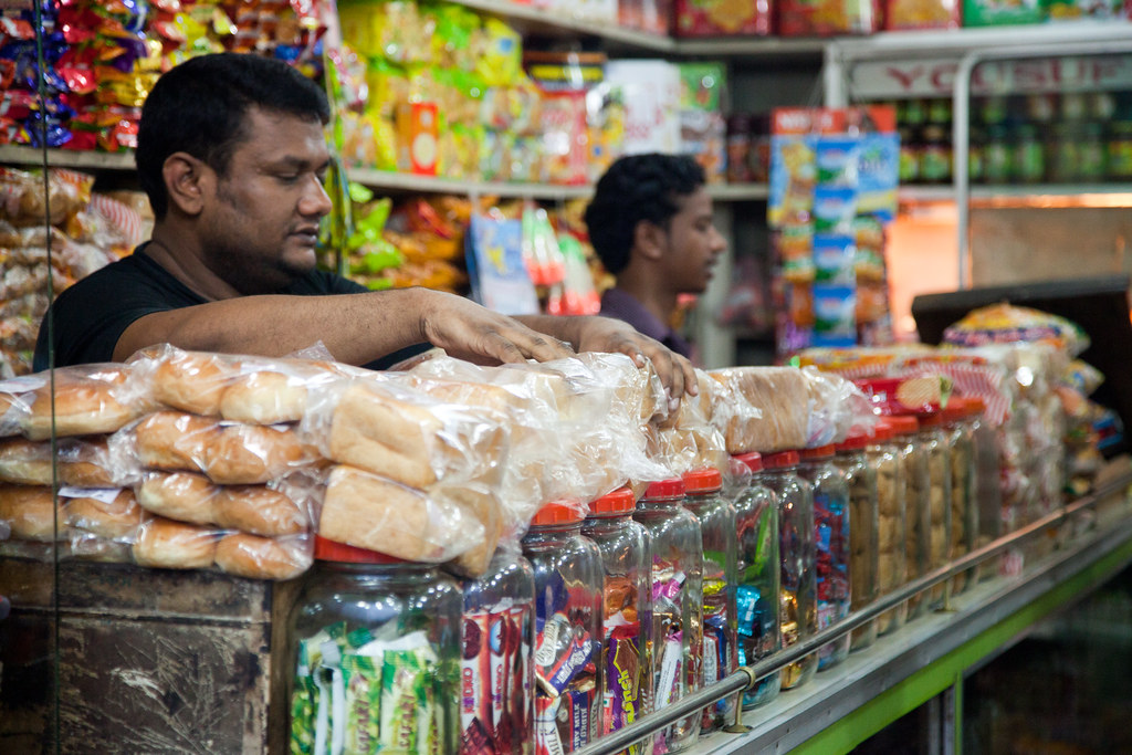 Selling bread in Bangladesh A shopkeeper arranges his disp… Flickr