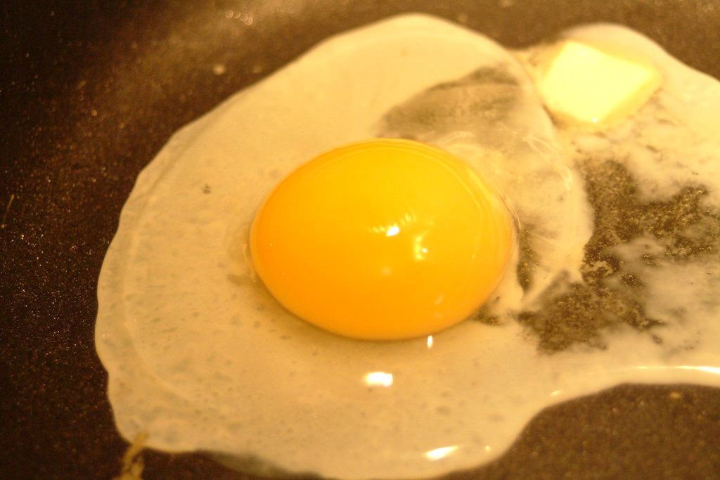 Raw Egg in Frying Pan A raw egg cooking in a frying pan. Flickr