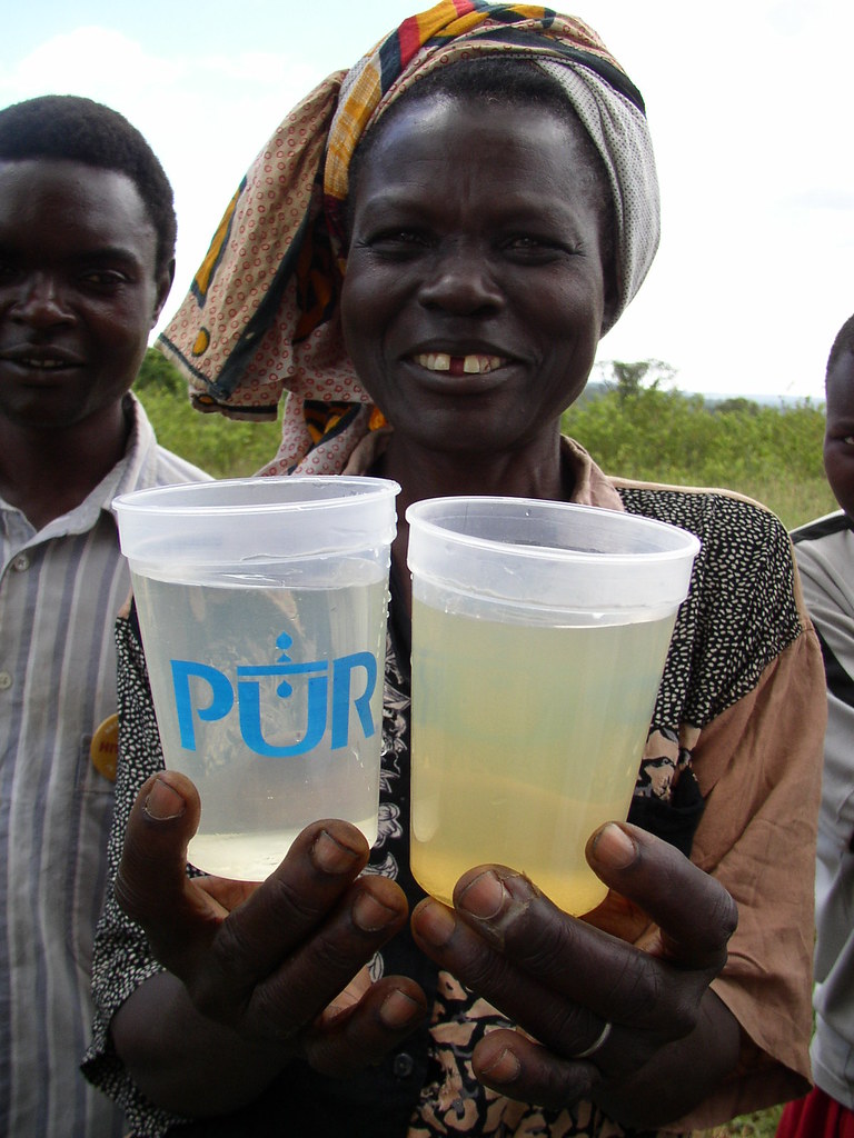Woman Shows Comparison of Dirty Water and Purified Water i… Flickr