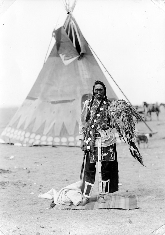 A medicine man of the Blood tribe standing in front of a t… Flickr