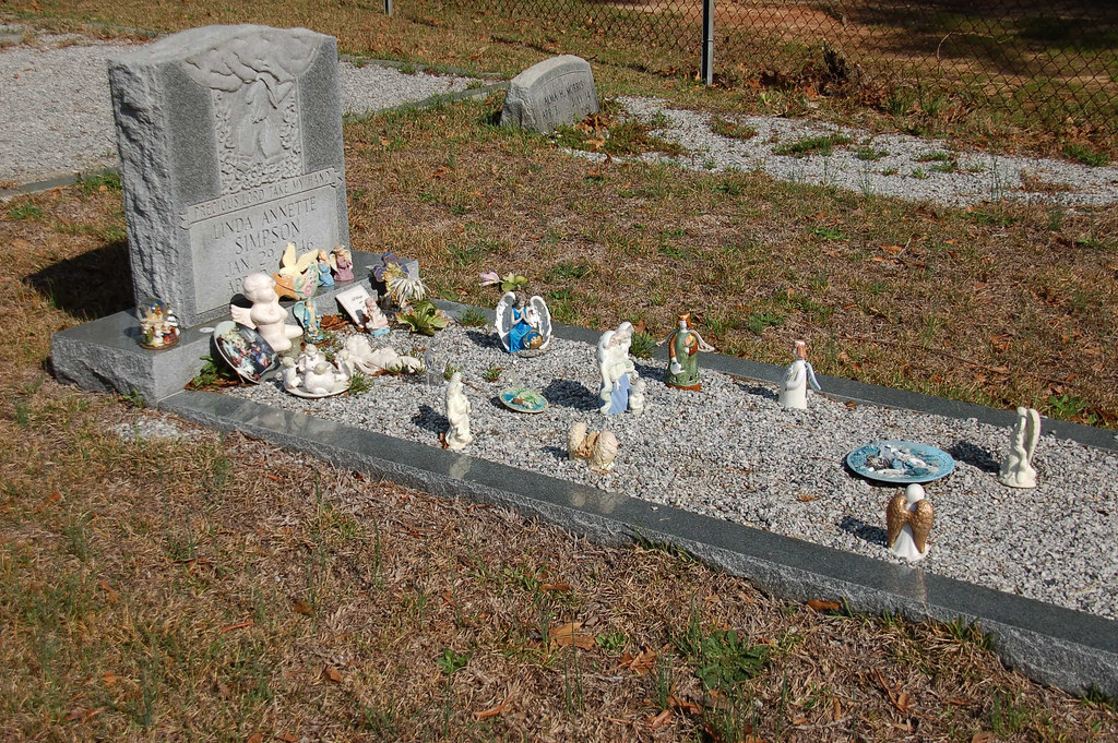 Grave Decorations Someone had place lots of angels and oth… Flickr