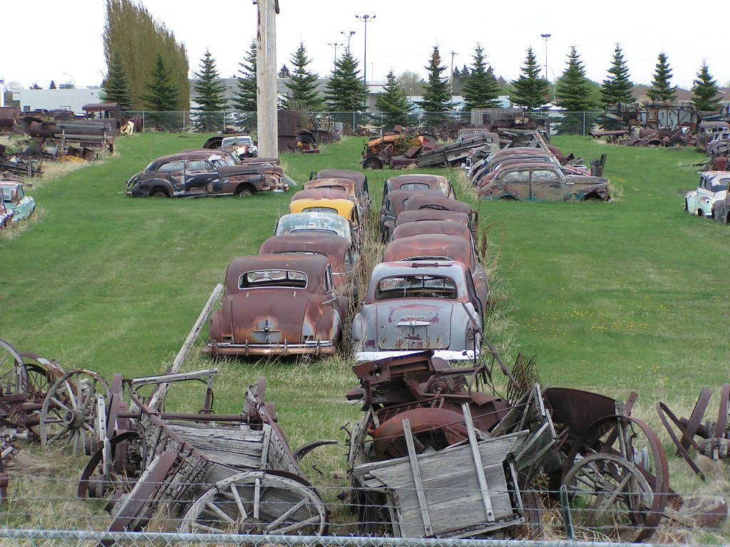 Old rusty cars and agricultural equipment A yard next to t… Flickr