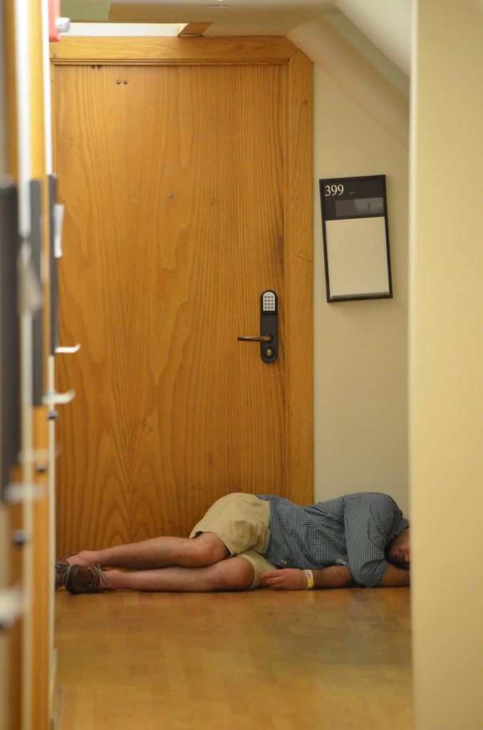 Sleeping It Off Some guy sleeping outside a dorm room in L… Flickr