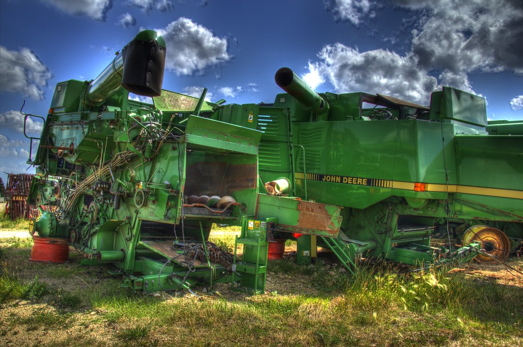 Salvage yard with a showroom shine A pair of John Deere co… Flickr