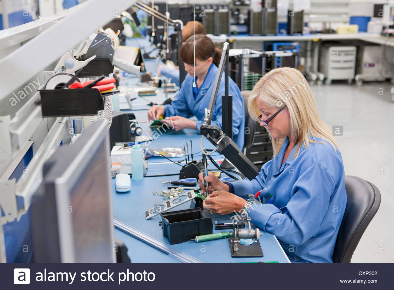 Technicians working on assembly line in hitech