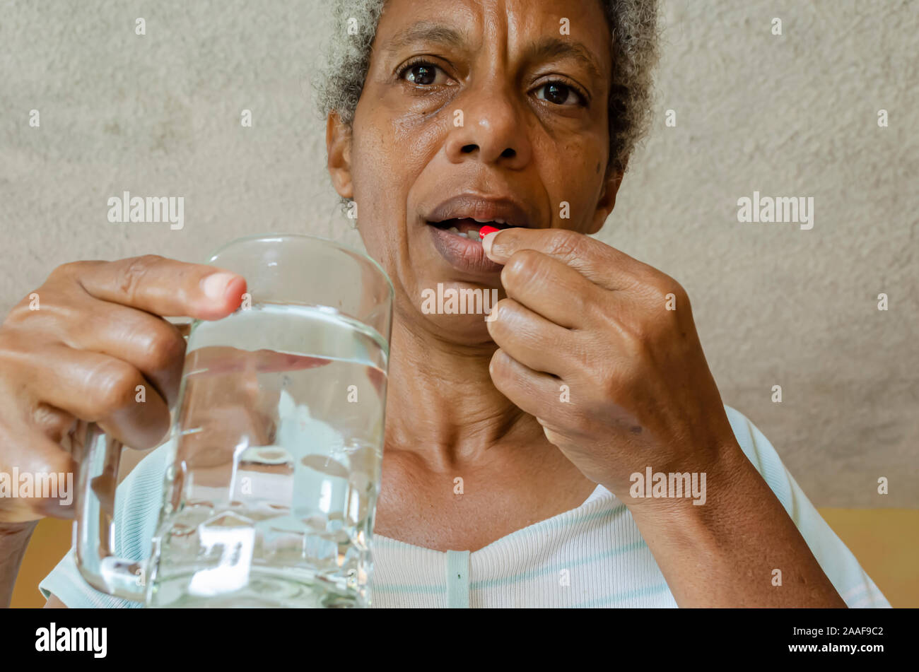 Senior Taking Tablets Stock Photo Alamy