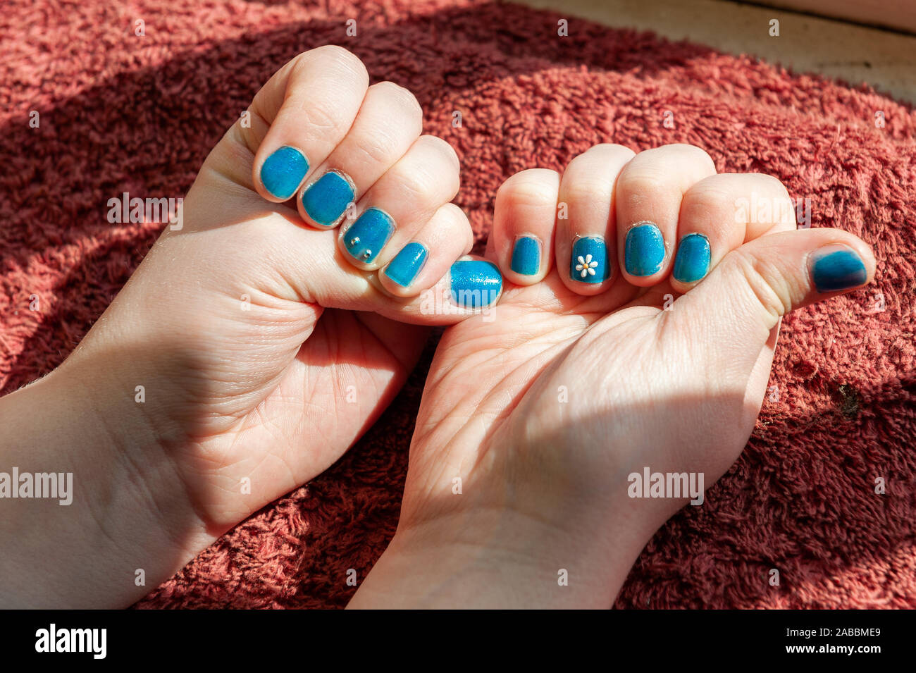 Vibrantly painted blue fingernails Stock Photo Alamy