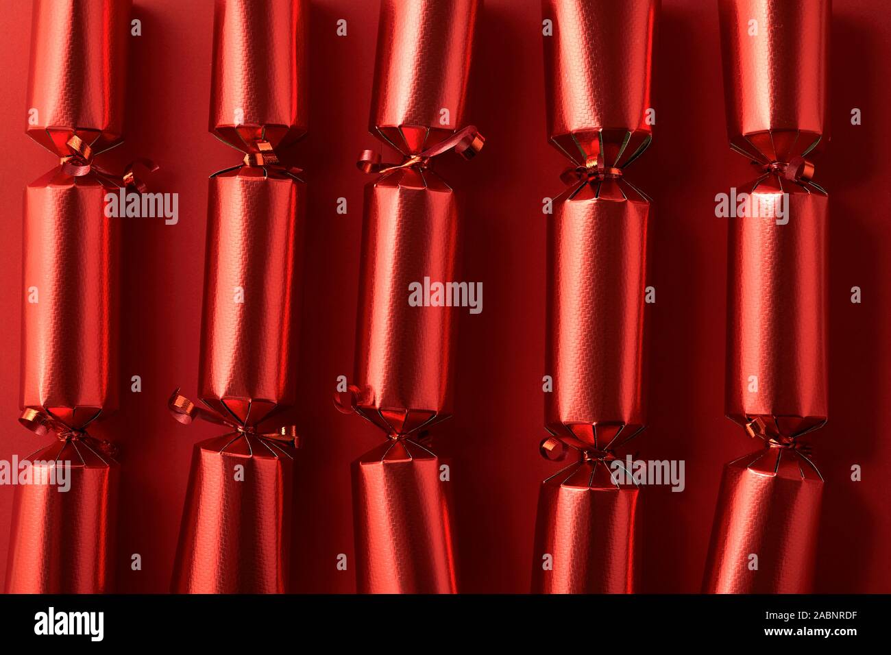 Red Christmas Crackers in a row Stock Photo Alamy