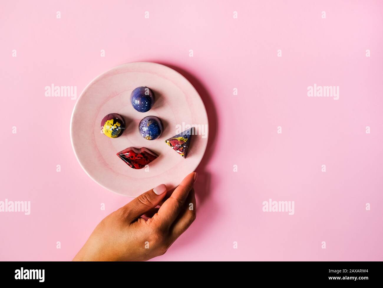 Hands and chocolates Stock Photo Alamy
