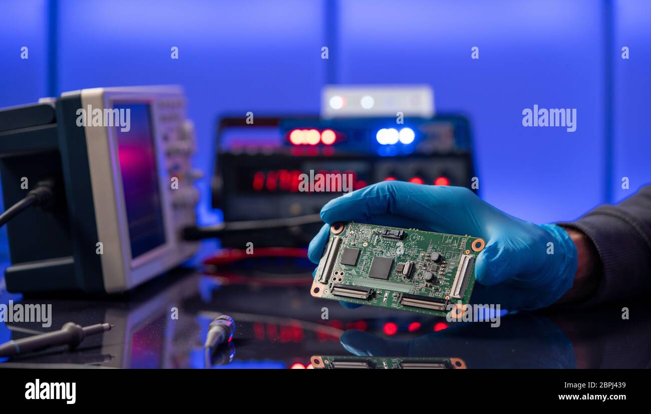 Debugging electronics device. PCB witch microcontroller in electronics laboratory Stock Photo