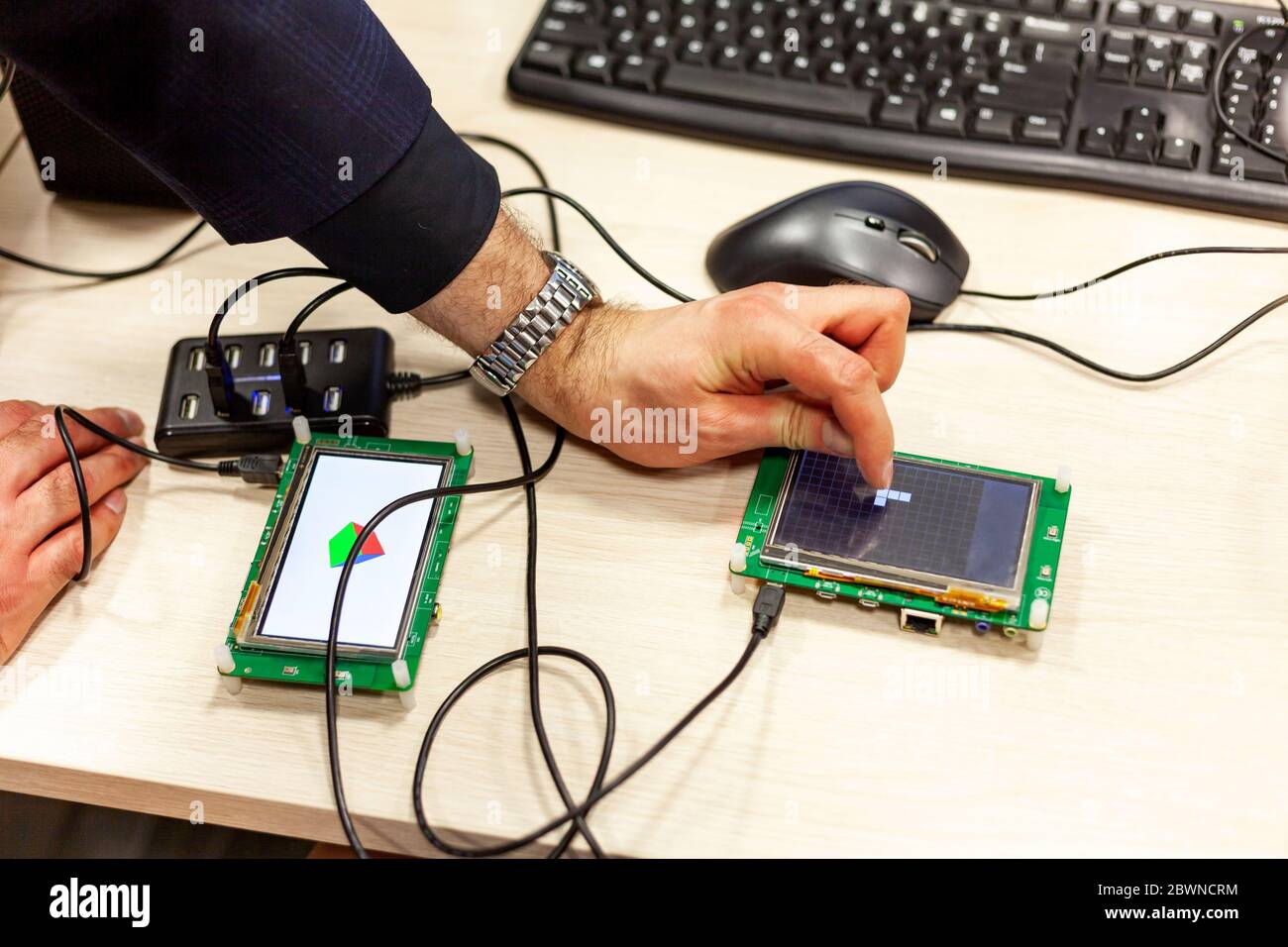 Man tapping, interacting with an lcd touch screen display on a single