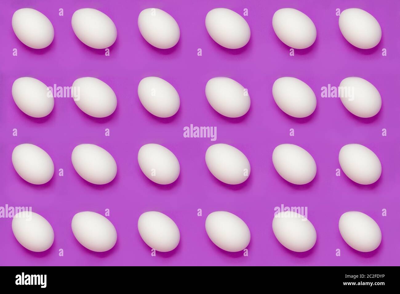 White eggs arranged on solid color background Stock Photo Alamy