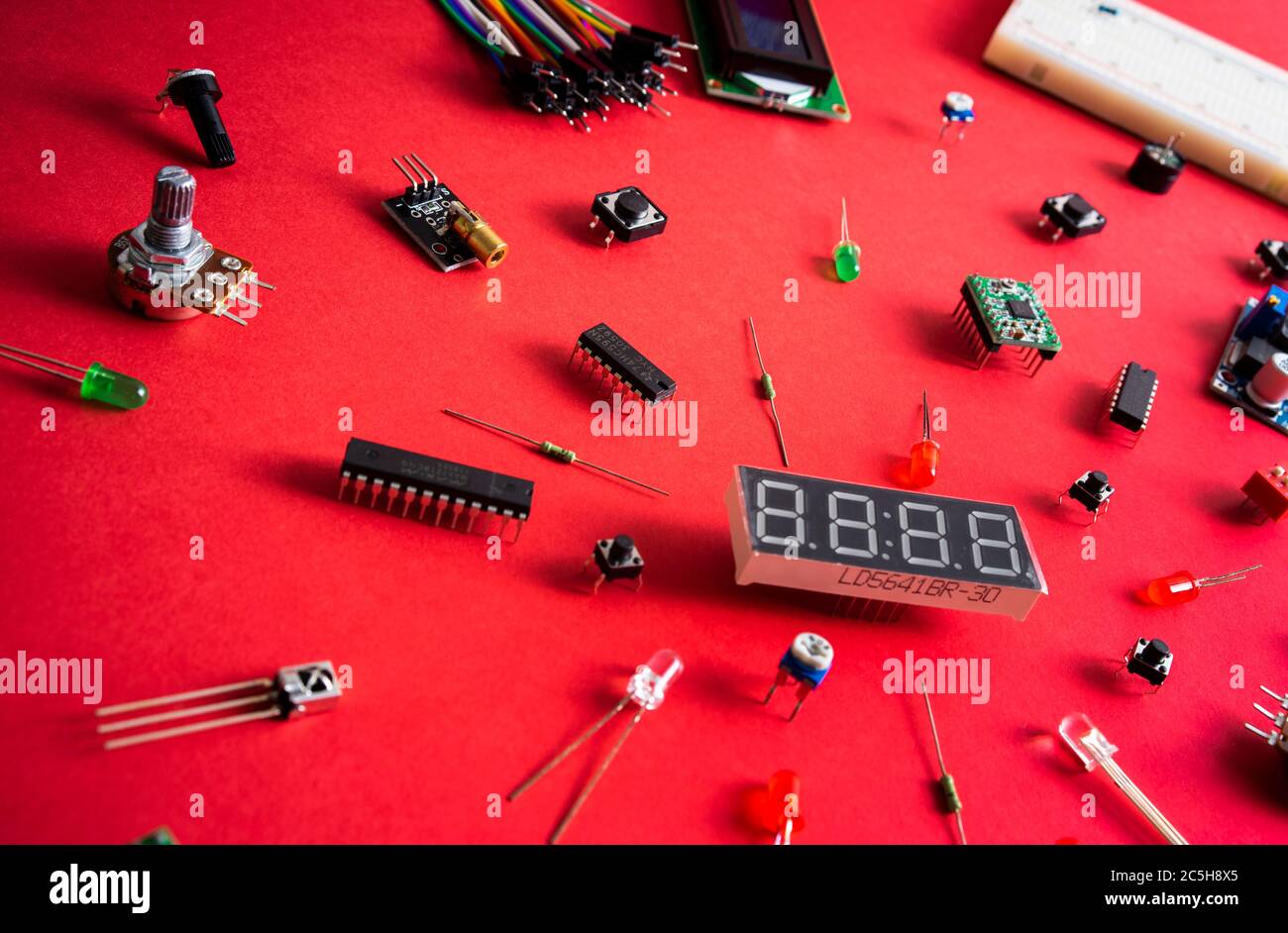 Micro electronics arduino DIY components over red background, top view