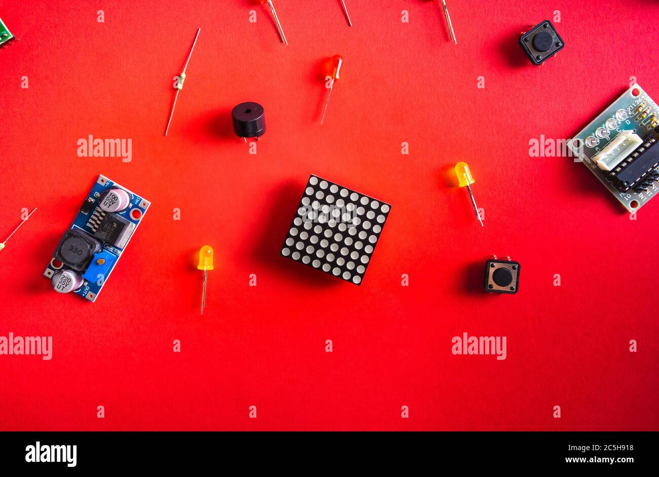 Micro electronics arduino DIY components over red background, top view