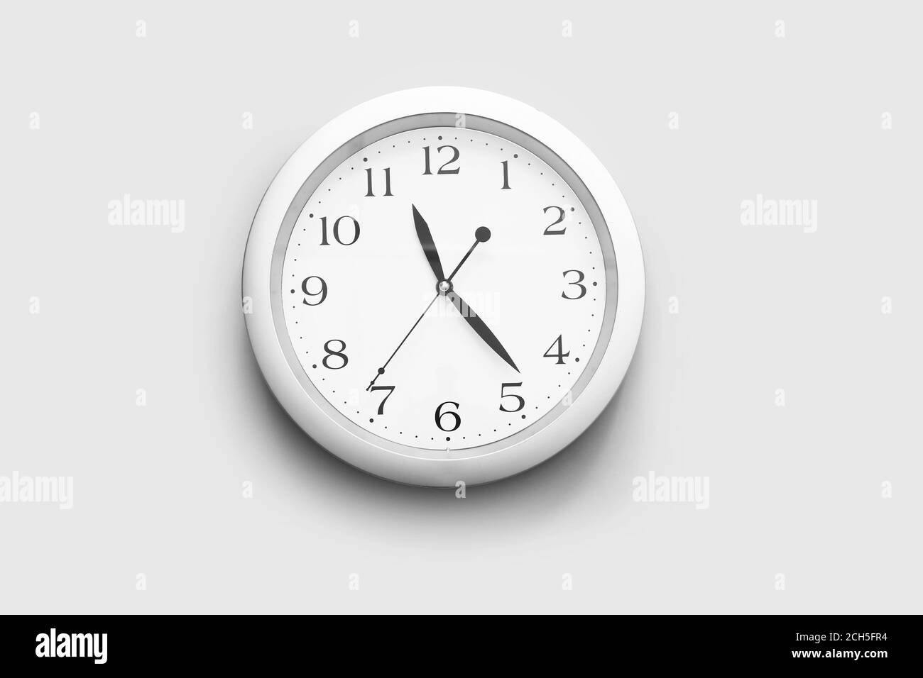 Simple clock on light background Stock Photo Alamy