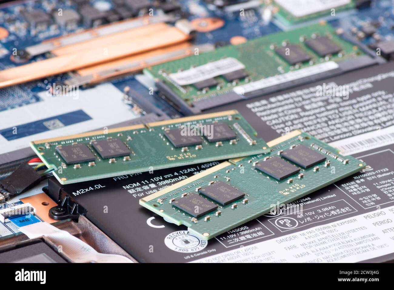 Image depicting an open laptop computer with memory or RAM sticks ready