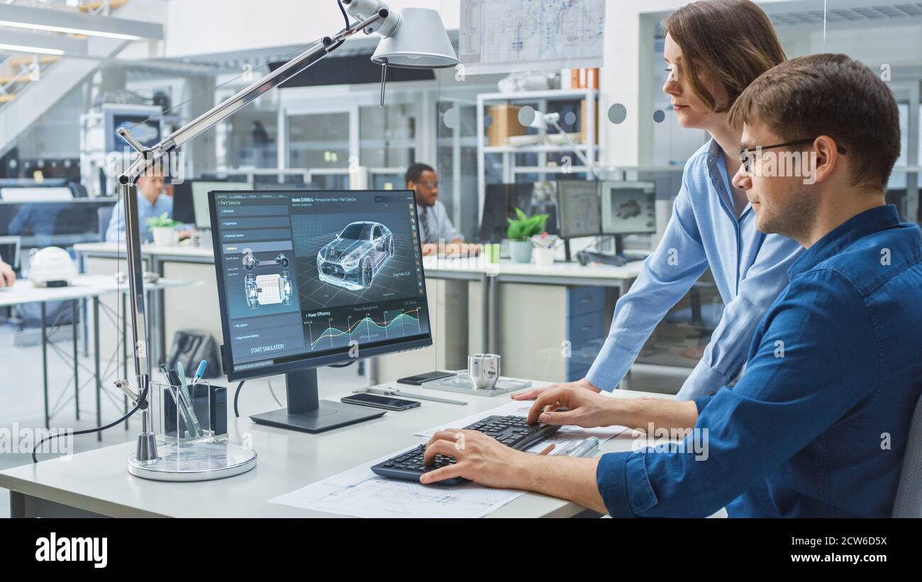 Engineer Talking With Project Manager and Working on Desktop Computer