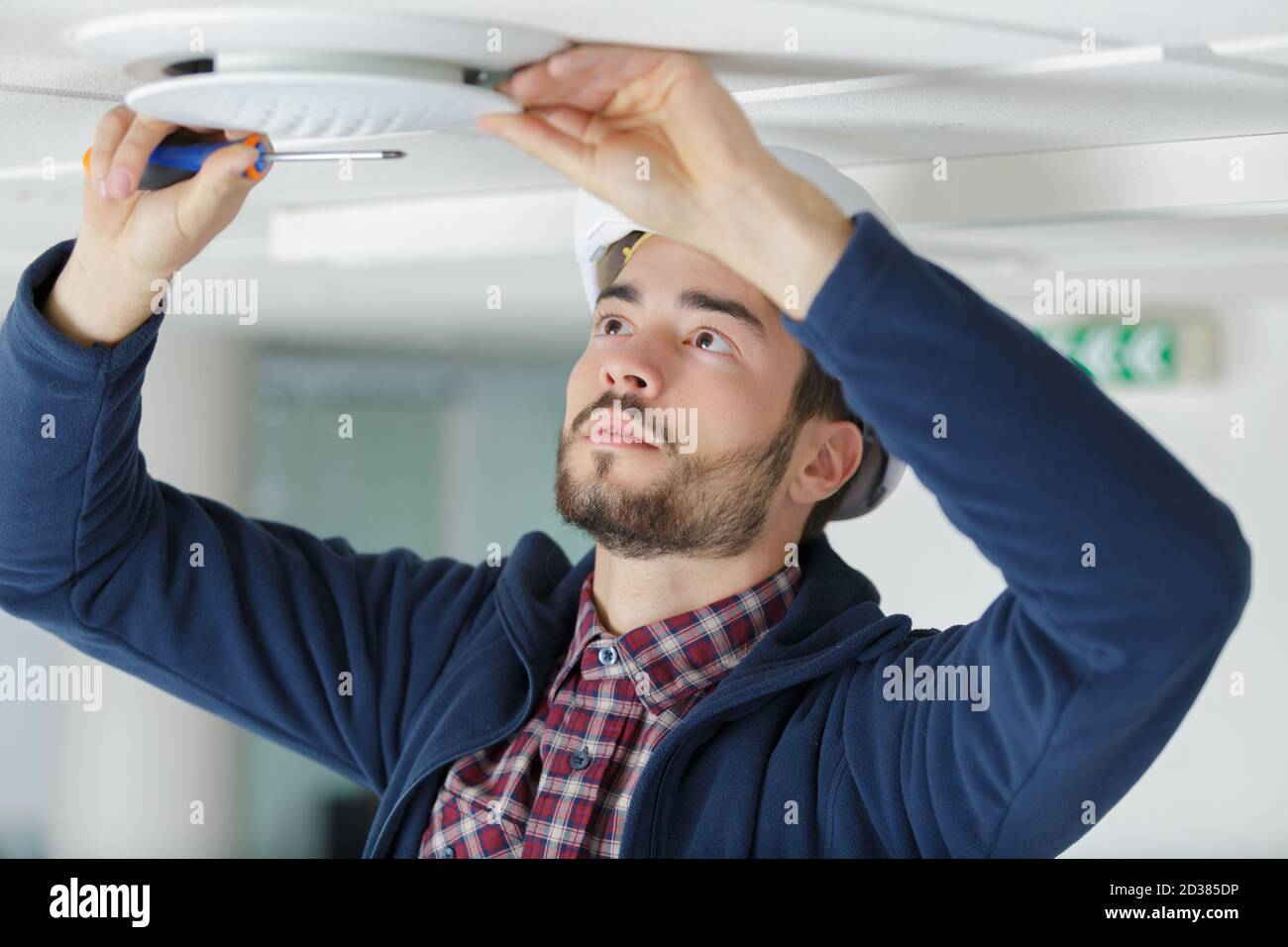electrician installing ceiling light Stock Photo Alamy