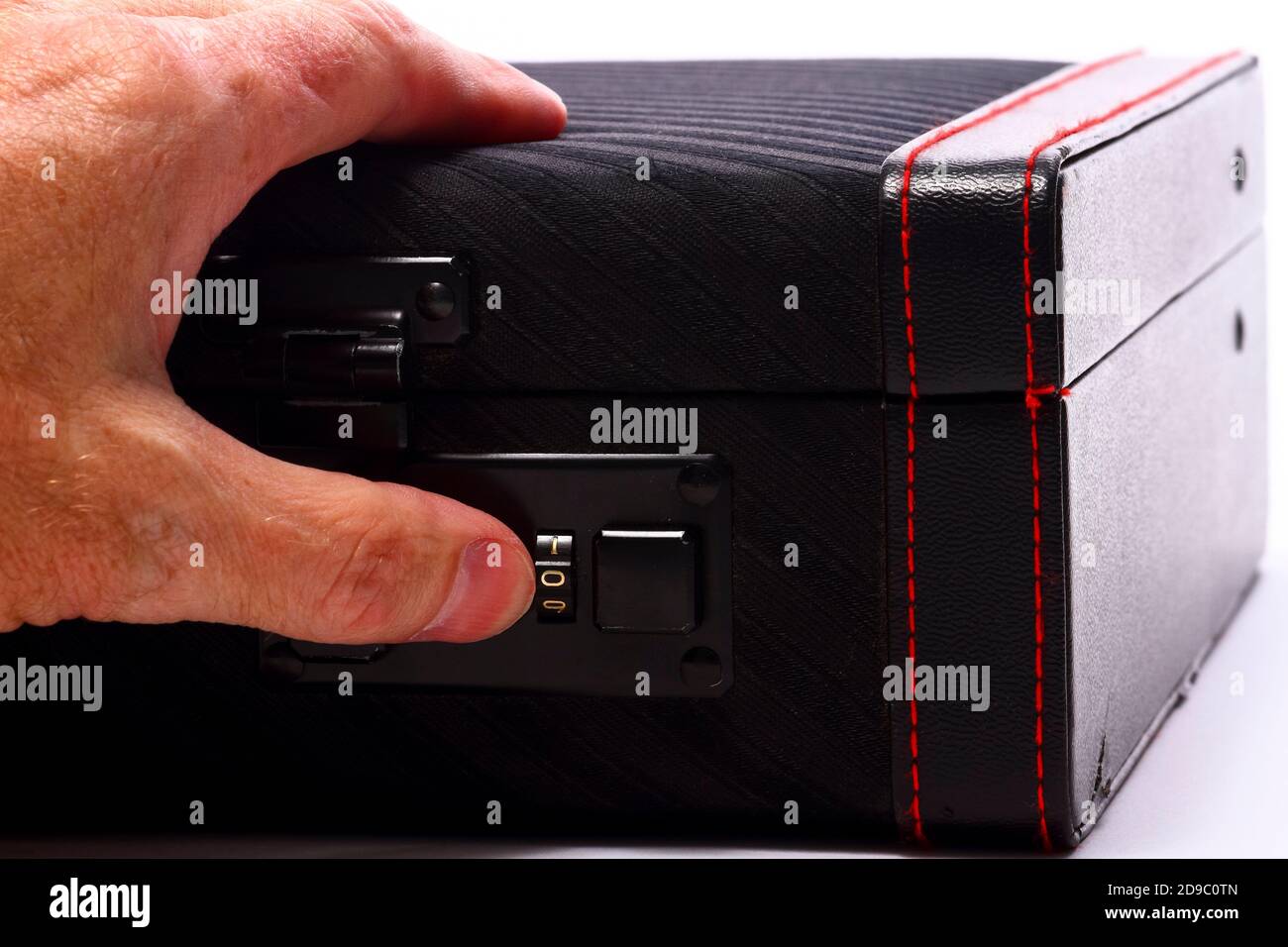 Mans hand inputing the code numbers for a combination lock on a