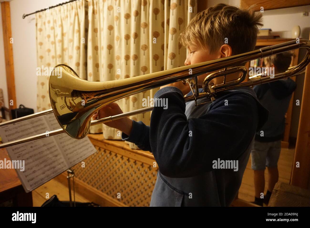 Boy playing trombone Stock Photo Alamy