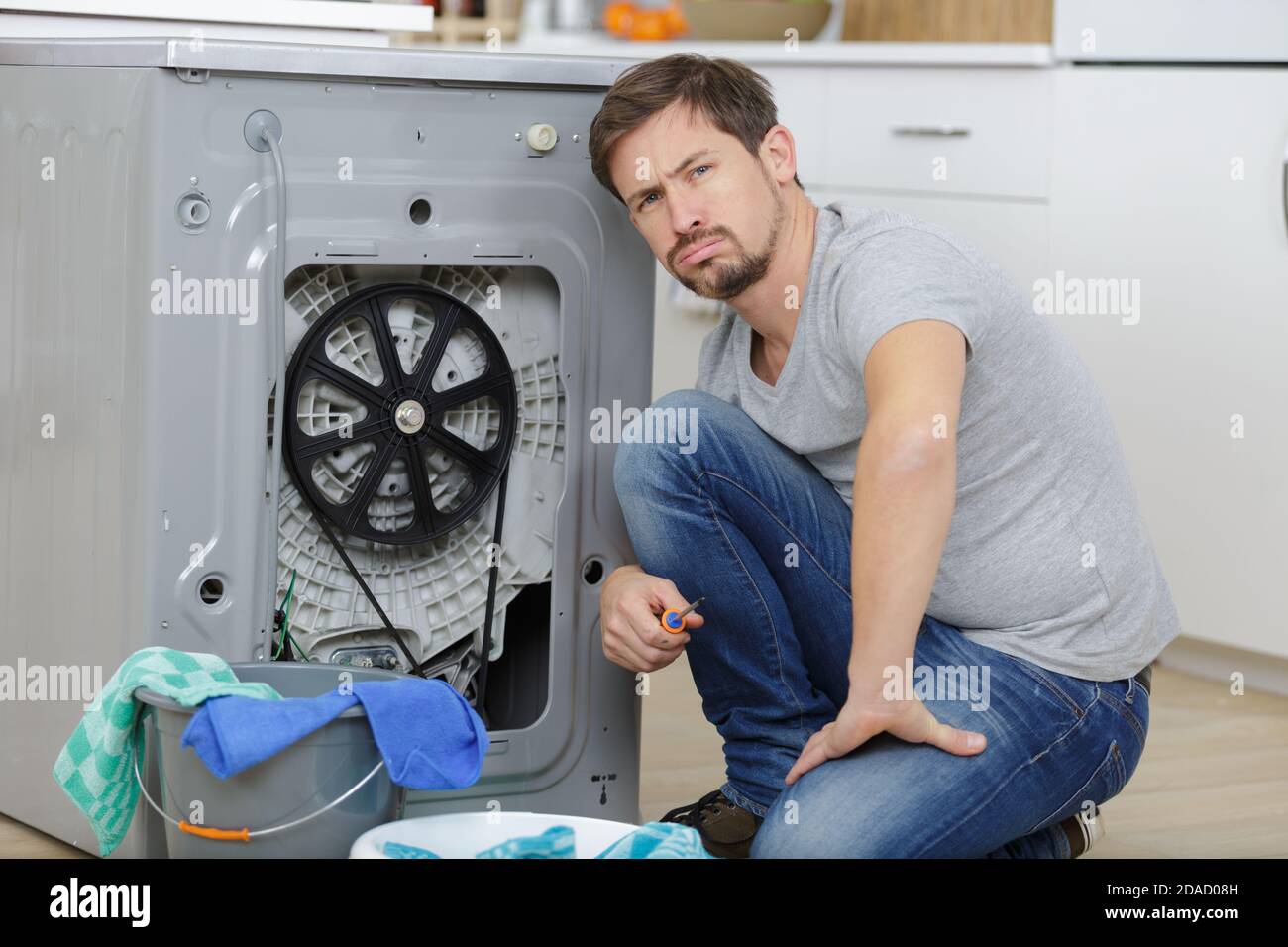 man checking washing machine issue Stock Photo Alamy
