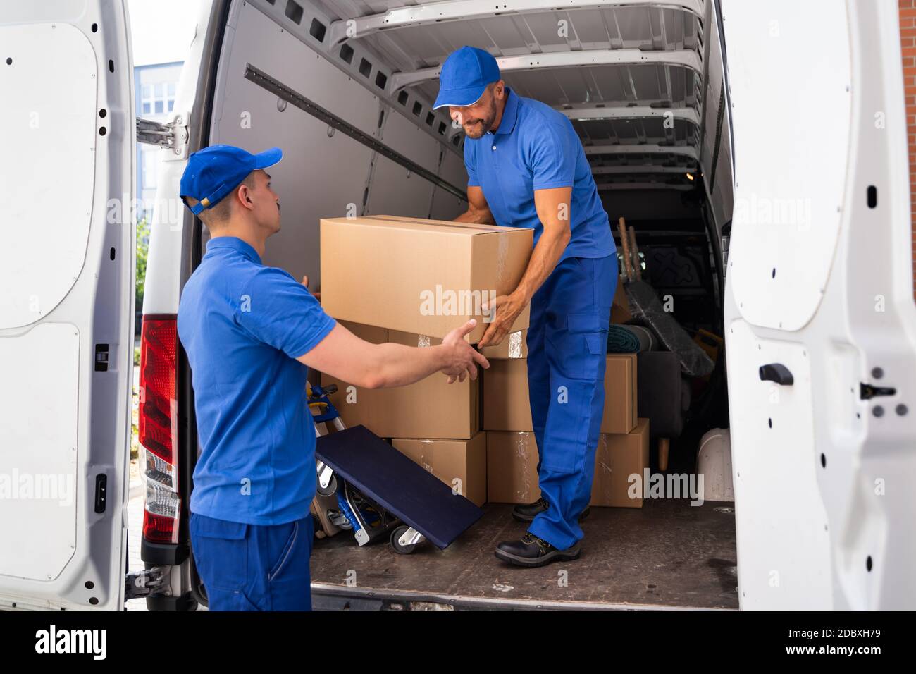 Home Moving Services. Movers Loading Van Or Truck Stock Photo Alamy