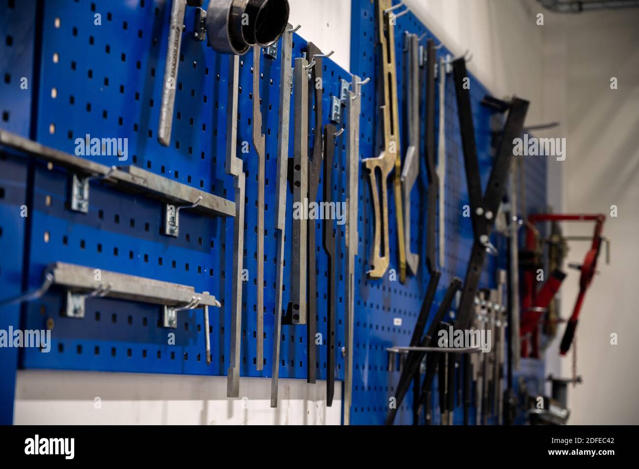 A wall with various tools hanging Stock Photo Alamy