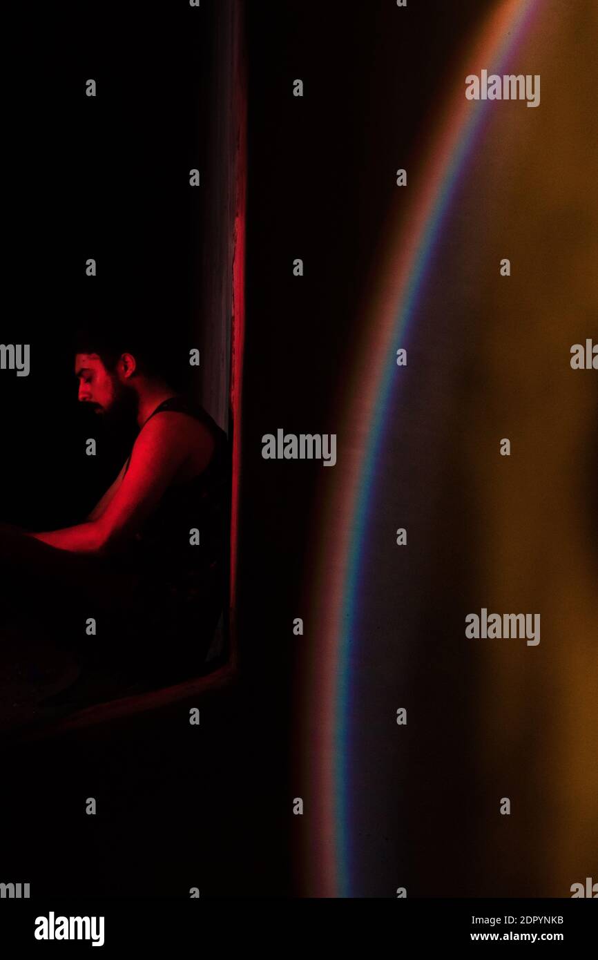 Man Sitting In Dark Room Stock Photo Alamy