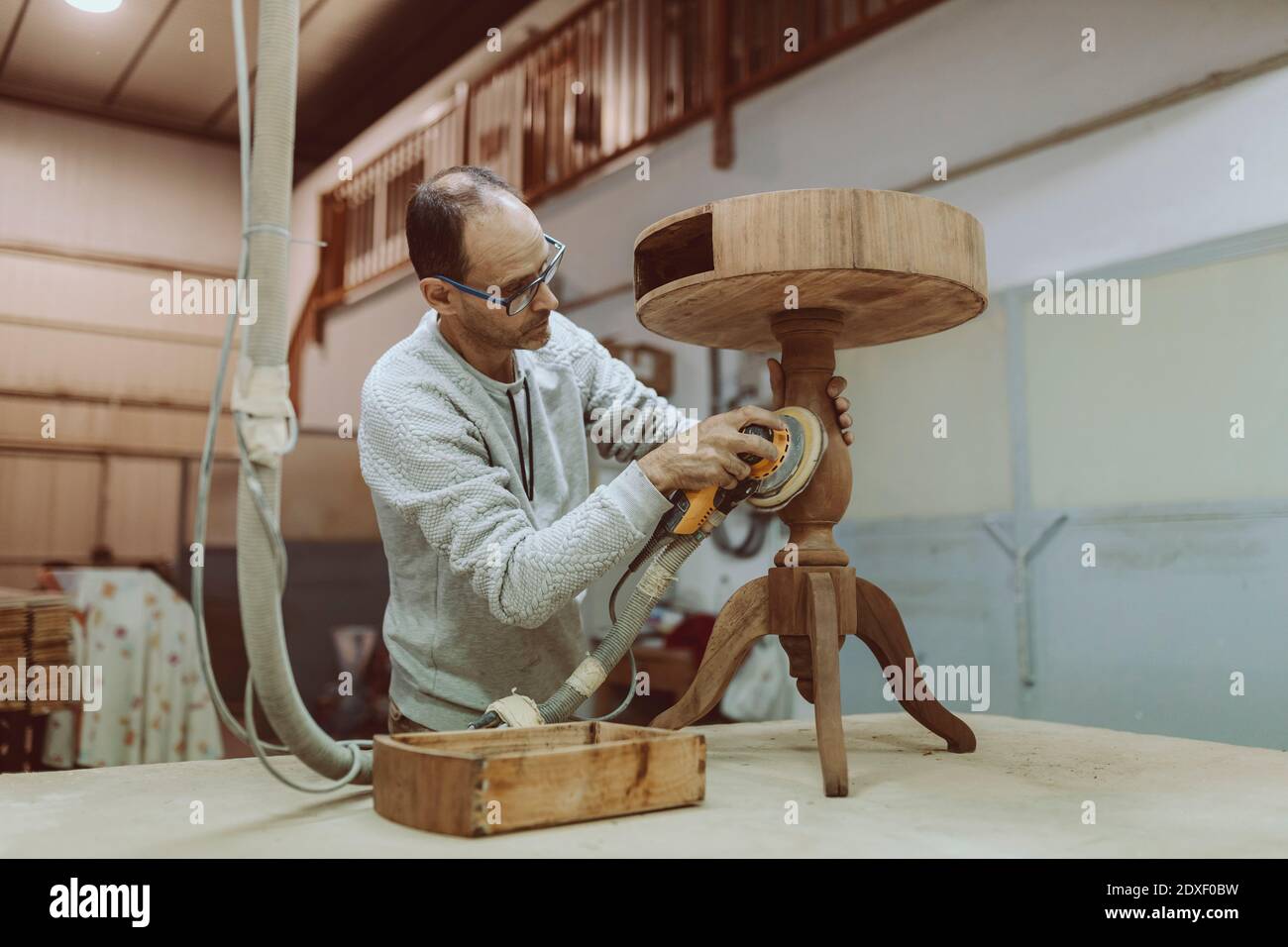 Carpenter using sander table while working at Stock Photo Alamy