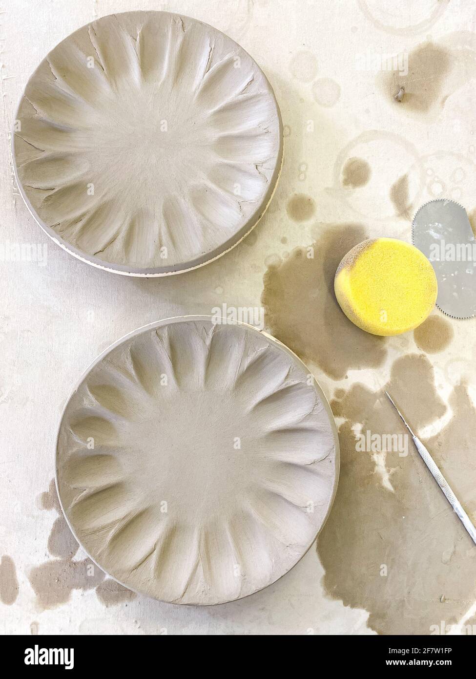 Ceramic clay plates with tool Stock Photo Alamy