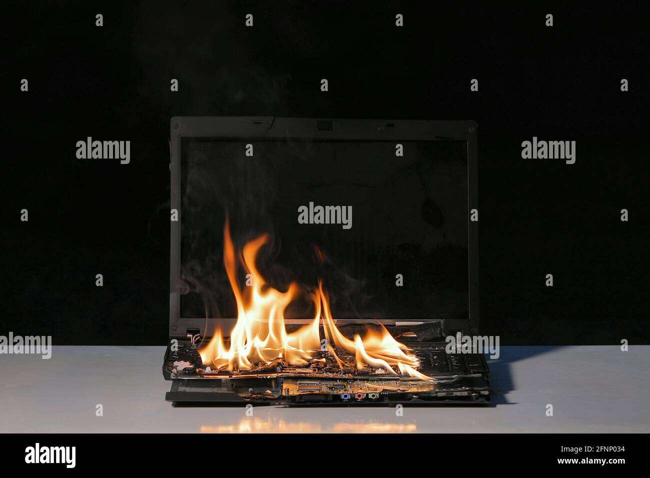 Burning laptop computer Stock Photo Alamy