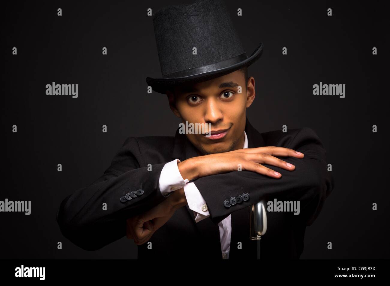 Handsome man in top hat posing with cane Stock Photo Alamy