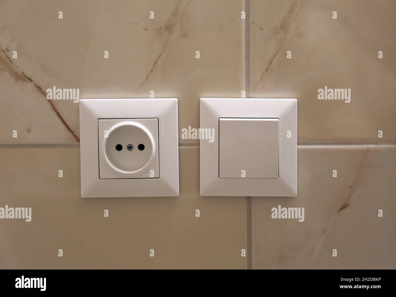 Electric socket and light switch on wall Stock Photo Alamy