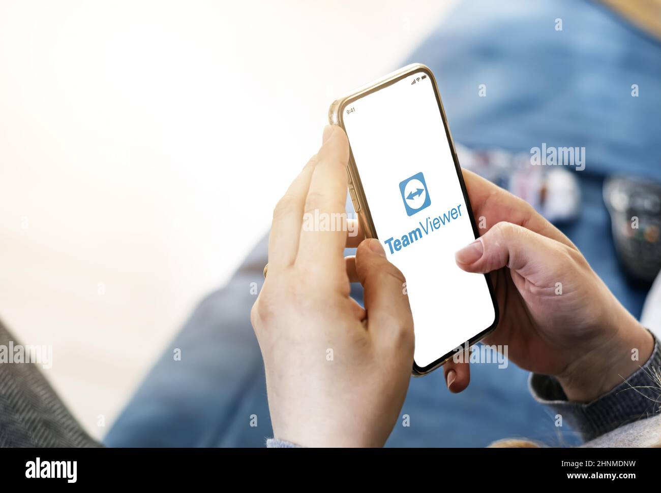 Woman using the TeamViewer mobile application to remotely control her