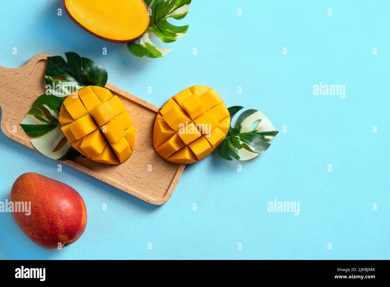Mango background design concept. Top view of diced fresh mango fruit