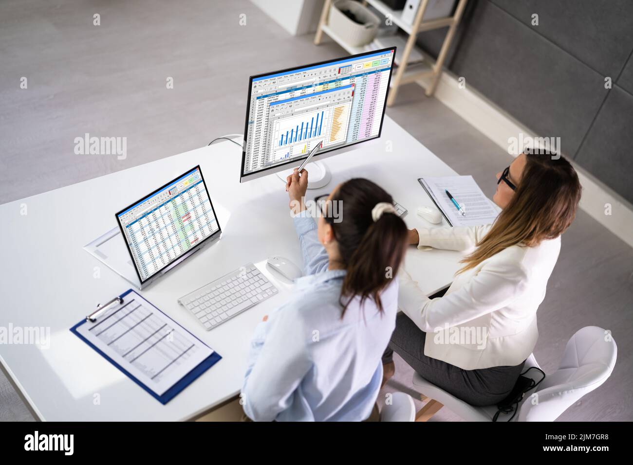 Analyst Employee Working On Spreadsheet Using Desktop Computer Stock