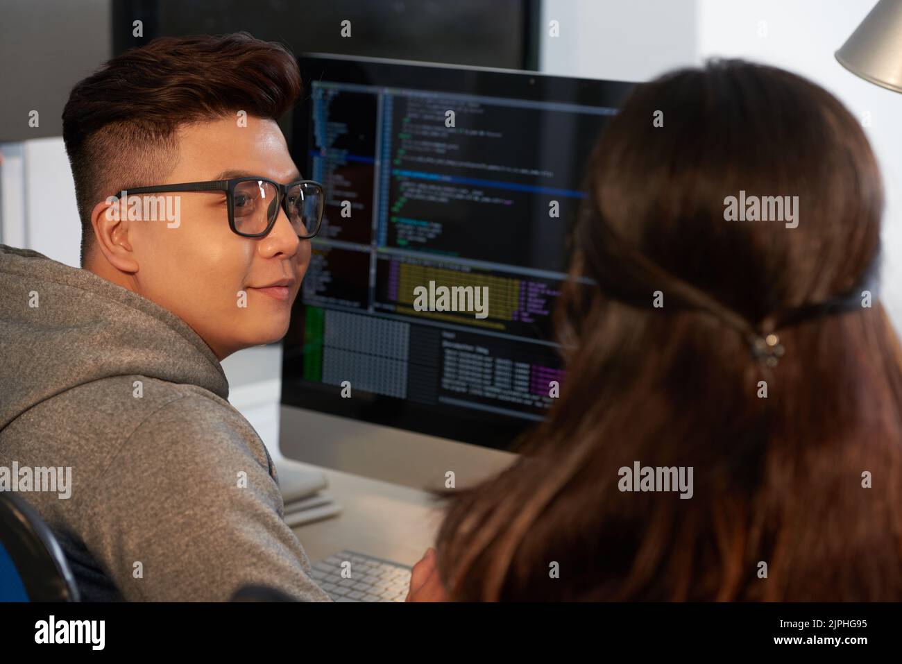 Group of talented programmers sitting in front of modern computer and