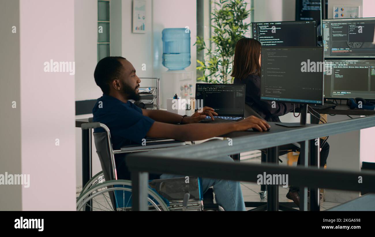 Software developer wheelchair user working on html script code
