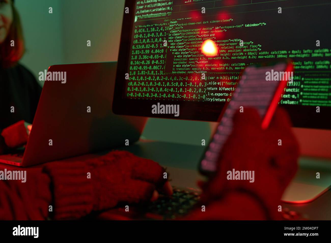 Anonymous people using computer and programming to break code. Cyber