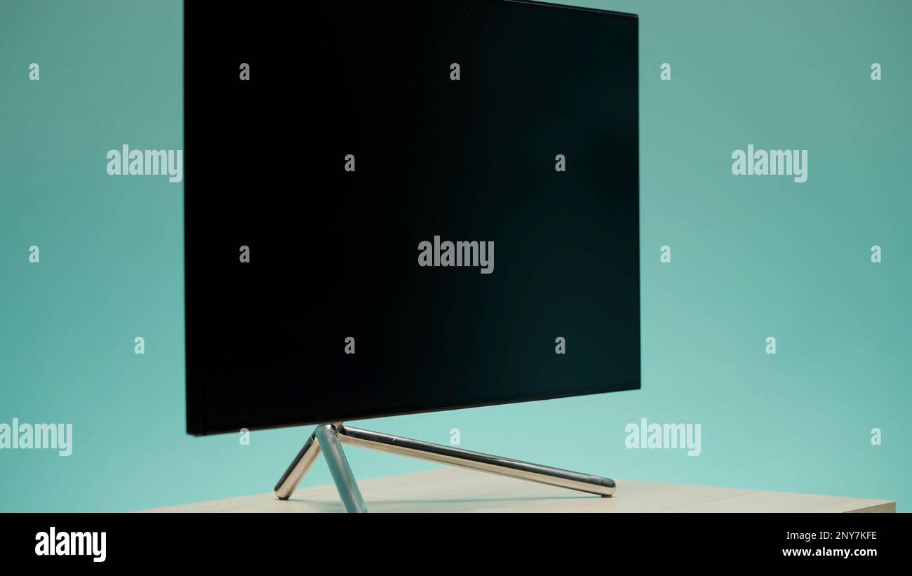 Flat monitor on a table surface spinning. Action. Computer monitor rotating slowly on the