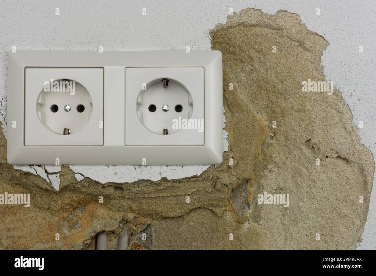 Wall plaster loosens around sockets Stock Photo Alamy