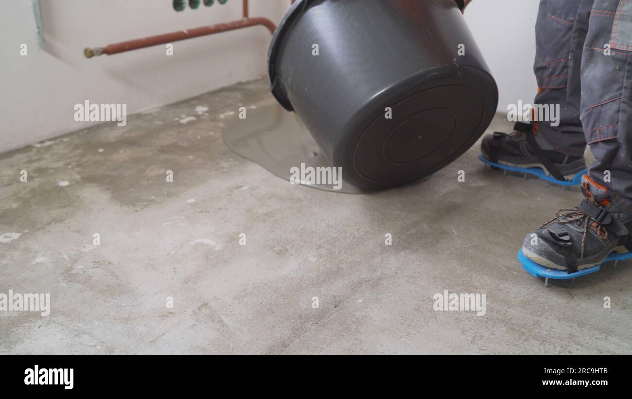 Liquid floor for leveling the base. A worker uses epoxy concrete screed