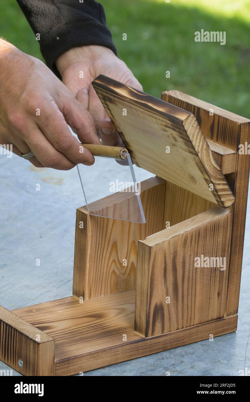 making a feeder for squirrels, step 11 plexiglass shield is fixed