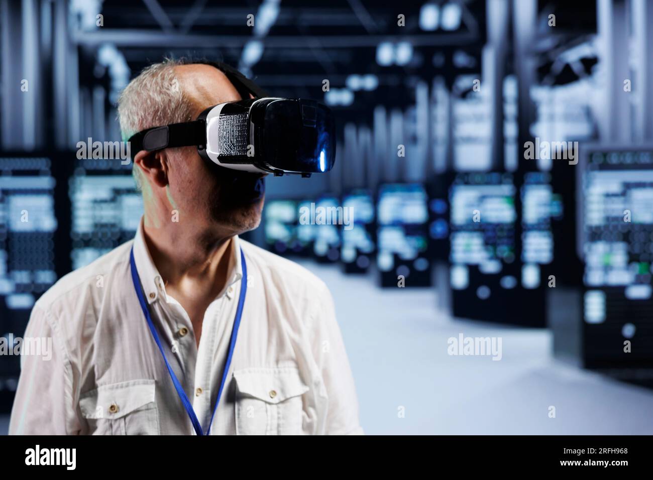 Aged computer scientist immersed in virtual reality at data center