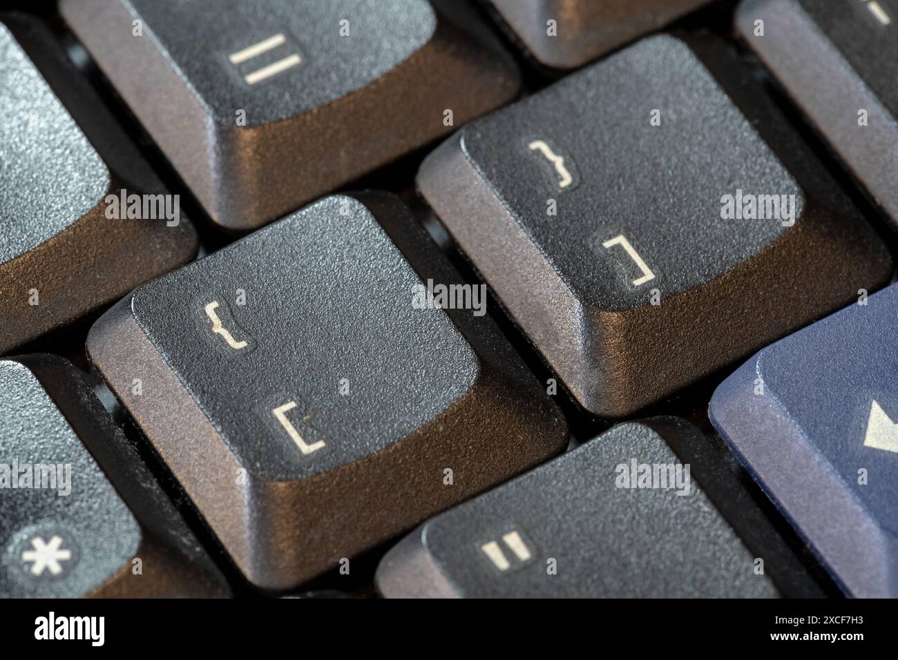 Curly brackets and square brackets, bracket symbol keys on a black