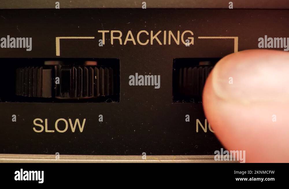 Extreme close up of a button on a vintage VCR adjusting the Tracking button Stock Video Footage