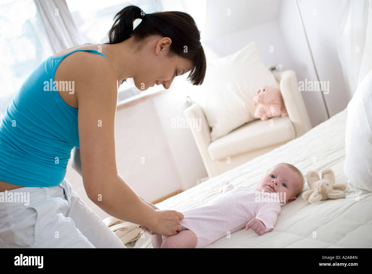mum dressing baby Stock Photo Alamy