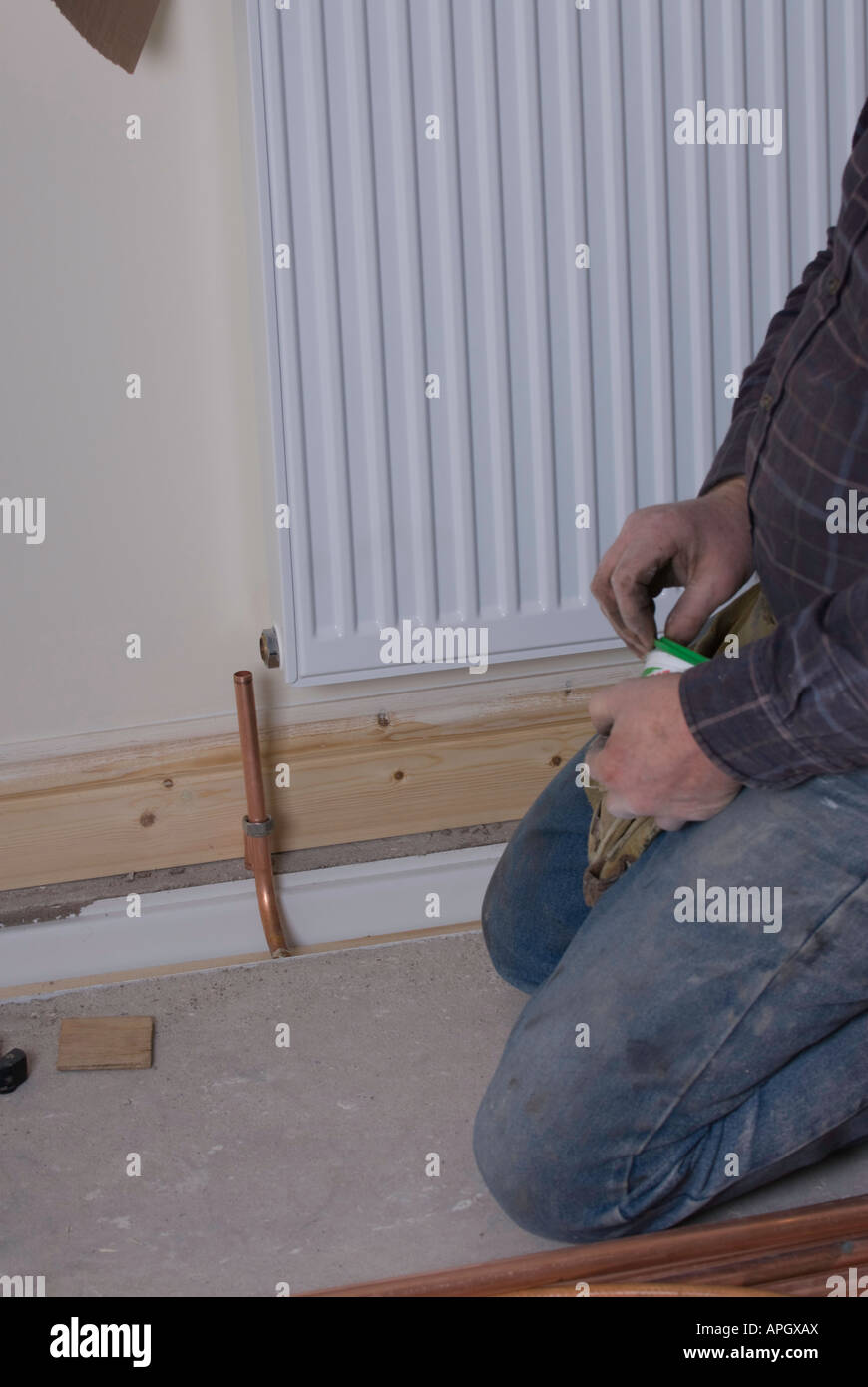 plumber fitting new radiator Stock Photo Alamy
